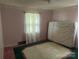 Bedroom with pink walls, one window, and a green rug at 8524 Anette Ave, Mint Hill, NC 28227