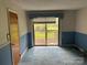 Bedroom with blue walls, carpet, and sliding glass doors to deck at 8524 Anette Ave, Mint Hill, NC 28227