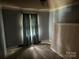 View of the bedroom with blue walls, a window with curtains, and a mattress at 8524 Anette Ave, Mint Hill, NC 28227