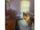 A bedroom featuring wooden furniture, green carpet and natural lighting from the window at 8524 Anette Ave, Mint Hill, NC 28227