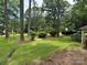 View of the large front yard with mature trees and black pickup truck parked on the side at 8524 Anette Ave, Mint Hill, NC 28227