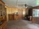 View of the living room featuring wood paneling, vintage furniture, and ample natural light at 8524 Anette Ave, Mint Hill, NC 28227