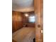 Living space featuring wood paneled walls, carpeted floor, a window, and built-in cabinets at 8524 Anette Ave, Mint Hill, NC 28227