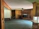 Spacious living room with a fireplace and wood paneling at 8524 Anette Ave, Mint Hill, NC 28227