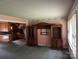 Cozy living room with pink walls, featuring vintage wall paper and seamless flow into the kitchen at 8524 Anette Ave, Mint Hill, NC 28227