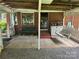 Covered brick patio with a swing at 8524 Anette Ave, Mint Hill, NC 28227
