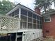 Screened in porch on a brick home with a wooden deck at 8524 Anette Ave, Mint Hill, NC 28227