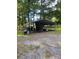 Exterior shot of the metal shed with carport in the backyard, great for outdoor storage at 8524 Anette Ave, Mint Hill, NC 28227