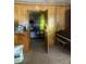Passage way with a door leading to more storage and a piano placed next to the opening at 8524 Anette Ave, Mint Hill, NC 28227