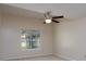 Neutral bedroom features a ceiling fan, window, and carpet at 8540 Indian Summer Trl, Harrisburg, NC 28075