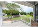 Inviting front porch with white railings overlooking a well-maintained lawn and quiet street at 8540 Indian Summer Trl, Harrisburg, NC 28075