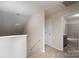 Bright upstairs hallway with neutral colors leads to the bathroom at 8540 Indian Summer Trl, Harrisburg, NC 28075