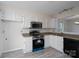 Modern kitchen with white cabinets, granite countertops, stainless steel appliances, and sleek backsplash at 8540 Indian Summer Trl, Harrisburg, NC 28075