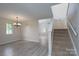 Spacious living room with wood floors, natural light, and staircase at 8540 Indian Summer Trl, Harrisburg, NC 28075