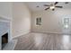 Inviting living room with fireplace, vaulted ceiling, and access to outdoor patio at 8540 Indian Summer Trl, Harrisburg, NC 28075