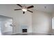 Bright living room with vaulted ceilings, ceiling fan, hardwood floors, and painted brick fireplace at 8540 Indian Summer Trl, Harrisburg, NC 28075