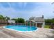 Backyard oasis featuring a sparkling blue pool and a wood deck providing a tranquil retreat and summer enjoyment at 8540 Indian Summer Trl, Harrisburg, NC 28075