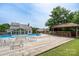 Backyard features a refreshing blue pool, a wooden deck, poolside bar, and comfortable seating perfect for summer gatherings at 8540 Indian Summer Trl, Harrisburg, NC 28075