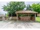 Outdoor bar on wooden deck includes seating; situated in backyard, perfect for poolside entertaining and summer relaxation at 8540 Indian Summer Trl, Harrisburg, NC 28075