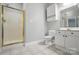 This bathroom features a glass shower, tiled floors, and a white vanity at 8731 Coralbell Ln, Charlotte, NC 28213