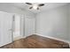 This bedroom features a ceiling fan, a closet, and hardwood floors at 8731 Coralbell Ln, Charlotte, NC 28213
