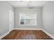 Bright bedroom with vinyl floors, a ceiling fan, and a window for ample natural light at 8731 Coralbell Ln, Charlotte, NC 28213