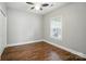 Bright bedroom featuring vinyl floors, a ceiling fan, and a window for ample natural light at 8731 Coralbell Ln, Charlotte, NC 28213