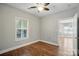 Bright bedroom featuring vinyl floors, a ceiling fan, and a window for ample natural light at 8731 Coralbell Ln, Charlotte, NC 28213