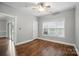 A cozy bedroom featuring sleek vinyl floors and a modern ceiling fan for added comfort at 8731 Coralbell Ln, Charlotte, NC 28213