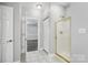 Hallway shot includes a bedroom, closet, and bathroom with glass shower at 8731 Coralbell Ln, Charlotte, NC 28213