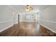 Open-concept living area with hardwood floors and convenient access to the kitchen at 8731 Coralbell Ln, Charlotte, NC 28213