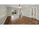 Open living room with hardwood floors, ceiling fan, and access to the outside patio at 8731 Coralbell Ln, Charlotte, NC 28213