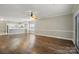 Inviting open-concept living space with hardwood floors, a kitchen, and natural light at 8731 Coralbell Ln, Charlotte, NC 28213
