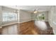 Bright living room with hardwood floors, a chandelier, and sliding glass doors to the outside at 8731 Coralbell Ln, Charlotte, NC 28213
