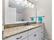 White bathroom vanity boasts granite countertop and black hardware at 9918 Windrow Dr, Indian Trail, NC 28079