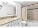 Bathroom featuring a granite countertop vanity and tiled shower and bath with curtain at 9918 Windrow Dr, Indian Trail, NC 28079