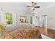 This bedroom features hardwood floors, white shutters, and tray ceiling and forest views at 9918 Windrow Dr, Indian Trail, NC 28079