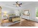 This bedroom features a ceiling fan, a tray ceiling, shutters, and a decorative wall hanging at 9918 Windrow Dr, Indian Trail, NC 28079