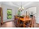 Dining room featuring wood table, large window with shutters, and hardwood floors at 9918 Windrow Dr, Indian Trail, NC 28079