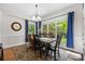 Bright dining room with large windows, a chandelier, and an elegant wooden dining table at 9918 Windrow Dr, Indian Trail, NC 28079
