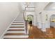 Elegant foyer with hardwood floors, staircase, chandelier, and views into other rooms at 9918 Windrow Dr, Indian Trail, NC 28079