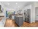 Modern kitchen featuring white cabinets, stainless steel appliances, and a center island with granite countertop at 9918 Windrow Dr, Indian Trail, NC 28079