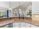 Close-up of a stylish kitchen sink with granite countertop and view to the outdoor living area at 9918 Windrow Dr, Indian Trail, NC 28079
