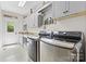 Bright laundry room boasts modern front load washer and dryer and built-in storage and granite countertop at 9918 Windrow Dr, Indian Trail, NC 28079
