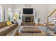 Cozy living room featuring a stone fireplace, built-in shelving, and comfortable seating at 9918 Windrow Dr, Indian Trail, NC 28079