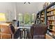 Living room featuring built-in bookshelves, large windows, and comfortable seating at 9918 Windrow Dr, Indian Trail, NC 28079