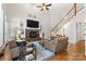 Inviting living room with fireplace, built-ins, staircase, and plush seating area, perfect for relaxing at 9918 Windrow Dr, Indian Trail, NC 28079