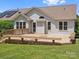 Spacious wooden deck in a grassy backyard of the home, plus view of solar panels on roof at 1028 Swaying Oats Dr, York, SC 29745