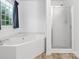 This bright bathroom features a garden tub and a glass enclosed shower at 1028 Swaying Oats Dr, York, SC 29745