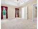 Main bedroom features a tray ceiling, ceiling fan, and a doorway leading to a walk in closet at 1028 Swaying Oats Dr, York, SC 29745